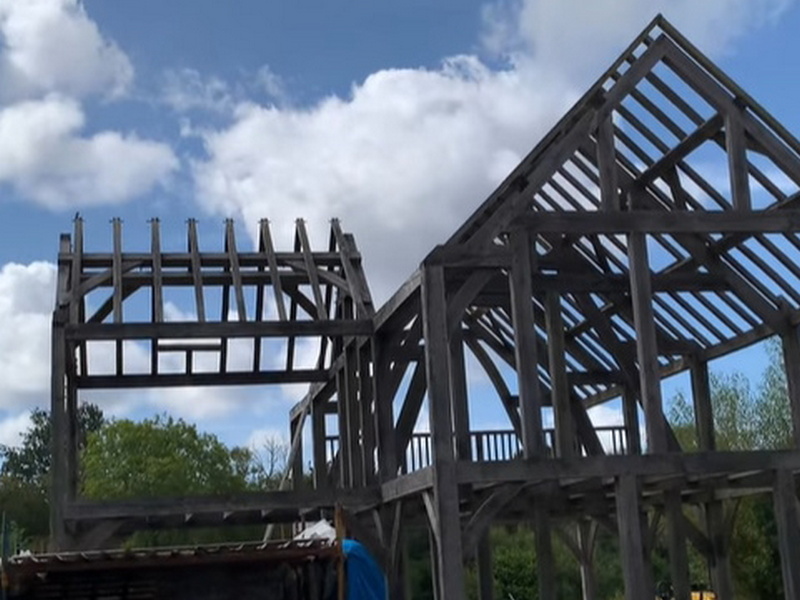 Traditional pegged oak framing paired with modern, low-impact building materials