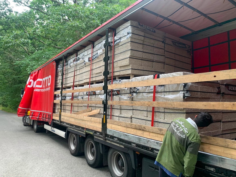 Natural materials arriving on site ready to wrap the traditional oak frame.